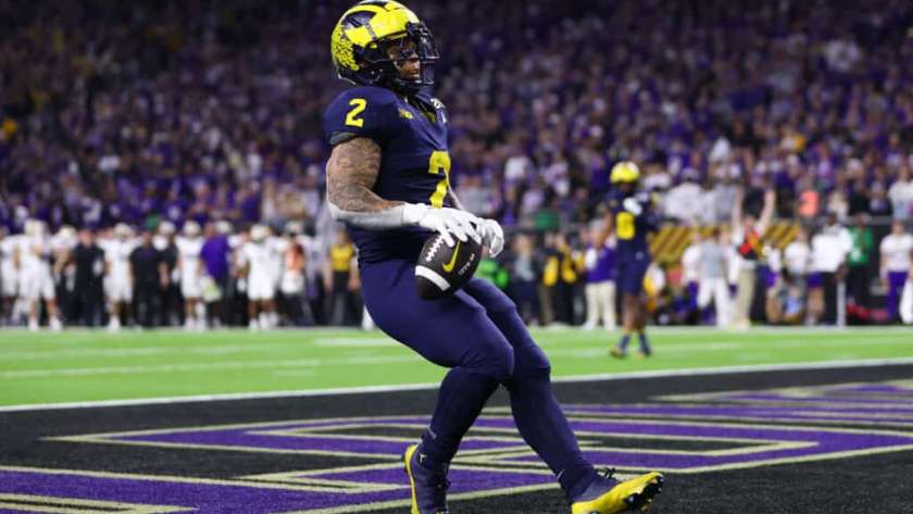 HOUSTON, TEXAS - JANUARY 08: Blake Corum #2 of the Michigan Wolverines scores a touchdown in the fourth quarter against the Washington Huskies during the 2024 CFP National Championship game at NRG Stadium on January 08, 2024 in Houston, Texas.
