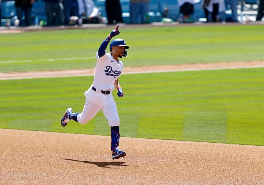 Mookie Betts #50 of the Los Angeles Dodgers celebrates as he runs the bases after hitting a one-run home run against pitcher Miles Mikolas #39 of the St. Louis Cardinals during the third inning on opening day at Dodger Stadium on March 28, 2024 in Los Angeles, California.