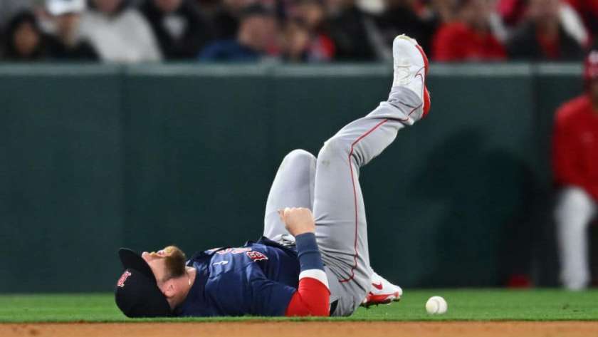 Trevor Story #10 of the Boston Red Sox reacts after being injured going after a ball hit by Mike Trout #27 of the Los Angeles Angels in the fourth inning during opening day of a Major League Baseball game at Angel Stadium of Anaheim on April 5, 2024 in Anaheim, California.