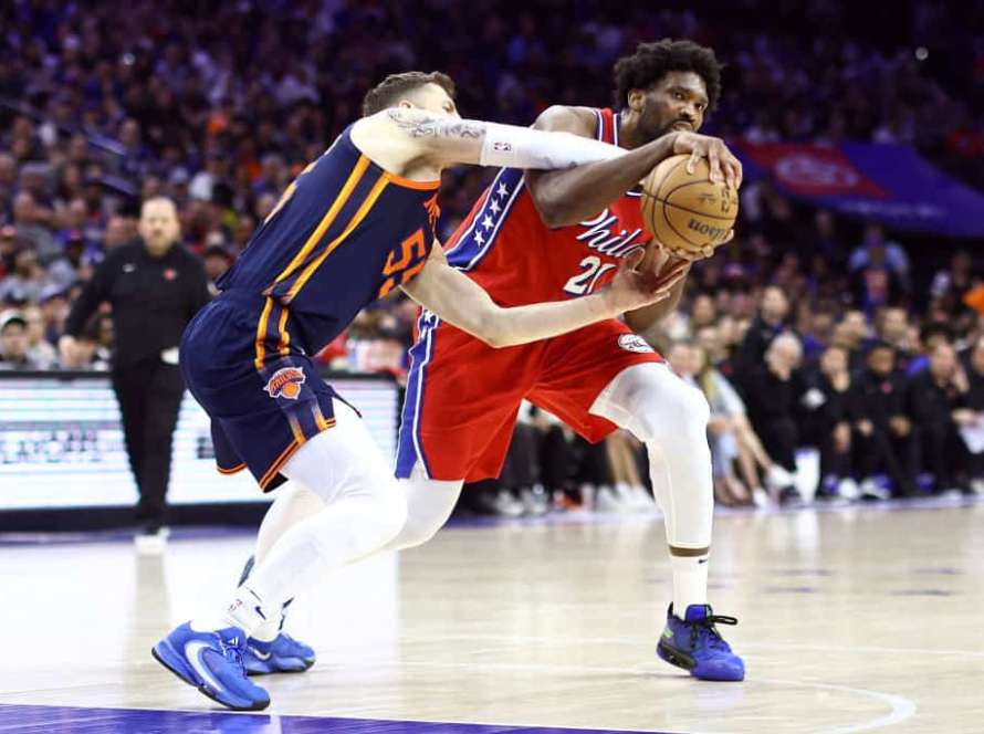 Joel Embiid #21 of the Philadelphia 76ers and Isaiah Hartenstein #55 of the New York Knicks challenge for the ball during the second quarter of game four of the Eastern Conference First Round Playoffs at the Wells Fargo Center on April 28, 2024 in Philadelphia, Pennsylvania.