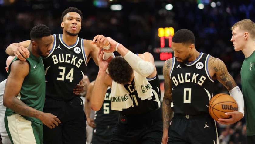 Giannis Antetokounmpo #34 of the Milwaukee Bucks is helped off the court by Thanasis Antetokounmpo #43 and Brook Lopez #11 after suffering an injury during the second half of a game against the Boston Celtics at Fiserv Forum on April 09, 2024 in Milwaukee, Wisconsin.