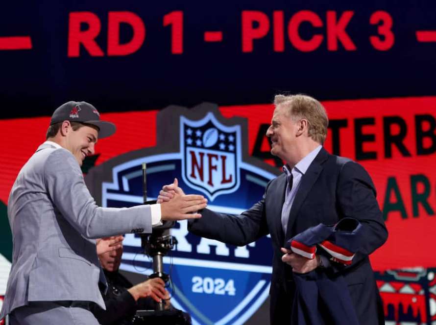 Drake Maye celebrates with NFL Commissioner Roger Goodell after being selected third overall by the New England Patriots during the first round of the 2024 NFL Draft at Campus Martius Park and Hart Plaza on April 25, 2024 in Detroit, Michigan.