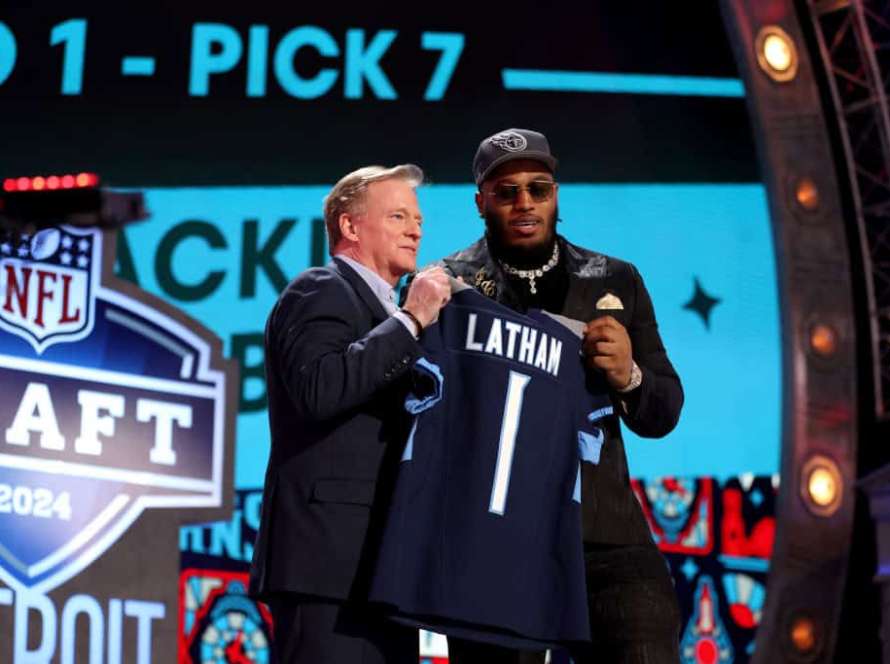 JC Latham poses with NFL Commissioner Roger Goodell after being selected seventh overall by the Tennessee Titans during the first round of the 2024 NFL Draft at Campus Martius Park and Hart Plaza on April 25, 2024 in Detroit, Michigan.