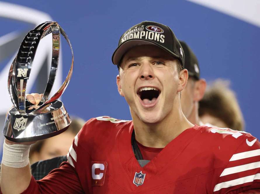 SANTA CLARA, CALIFORNIA - JANUARY 28: Brock Purdy #13 of the San Francisco 49ers reacts as he holds the George Halas Trophy after defeating the Detroit Lions 34-31 in the NFC Championship Game at Levi's Stadium on January 28, 2024 in Santa Clara, California.