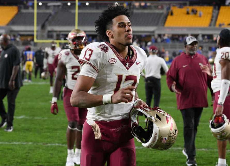 Jordan Travis #13 of the Florida State Seminoles runs off the field following a 24-7 win over the Pittsburgh Panthers during the game at Acrisure Stadium on November 4, 2023 in Pittsburgh, Pennsylvania.