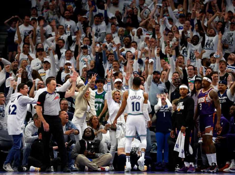 Mike Conley #10 of the Minnesota Timberwolves celebrates his three-point basket against the Phoenix Suns in the fourth quarter of game two of the Western Conference First Round Playoffs at Target Center on April 23, 2024 in Minneapolis, Minnesota. The Timberwolves defeated the Sun 105-93.