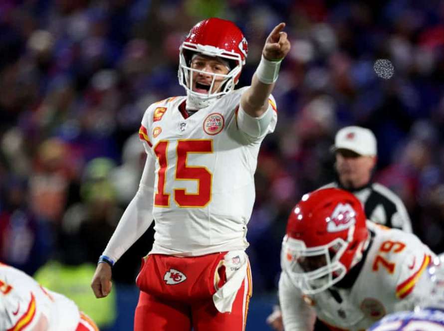 Patrick Mahomes #15 of the Kansas City Chiefs points against the Buffalo Bills during the second quarter in the AFC Divisional Playoff game at Highmark Stadium on January 21, 2024 in Orchard Park, New York.