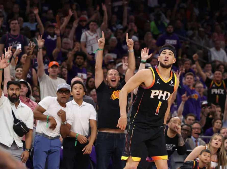 Devin Booker #1 of the Phoenix Suns watches a three-point shot against the Minnesota Timberwolves during the second half of game four of the Western Conference First Round Playoffs at Footprint Center on April 28, 2024 in Phoenix, Arizona. The Timberwolves defeated the Suns 122-116 and win the series 4-0.