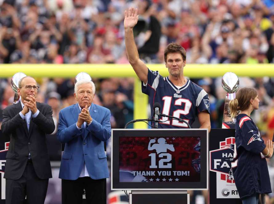 New England Patriots President Jonathan Kraft, New England Patriots owner Robert Kraft clap as former New England Patriots quarterback Tom Brady celebrates during a ceremony honoring Brady at halftime of New England's game against the Philadelphia Eagles at Gillette Stadium on September 10, 2023 in Foxborough, Massachusetts.
