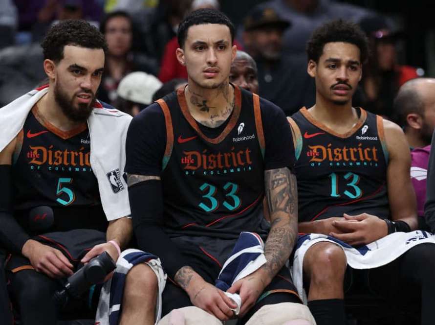 Tyus Jones #5, Kyle Kuzma #33, and Jordan Poole #13 of the Washington Wizards look on from the bench /H during the first half at Capital One Arena on February 2, 2024 in Washington, DC.