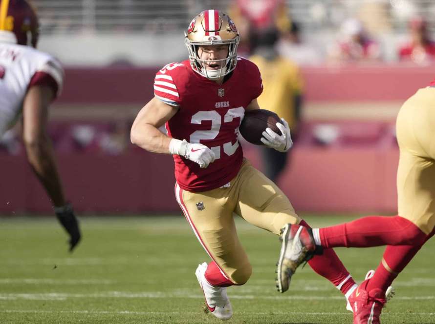 Christian McCaffrey #23 of the San Francisco 49ers carries the ball against the Washington Commanders during the first half of the game at Levi's Stadium on December 24, 2022 in Santa Clara, California.