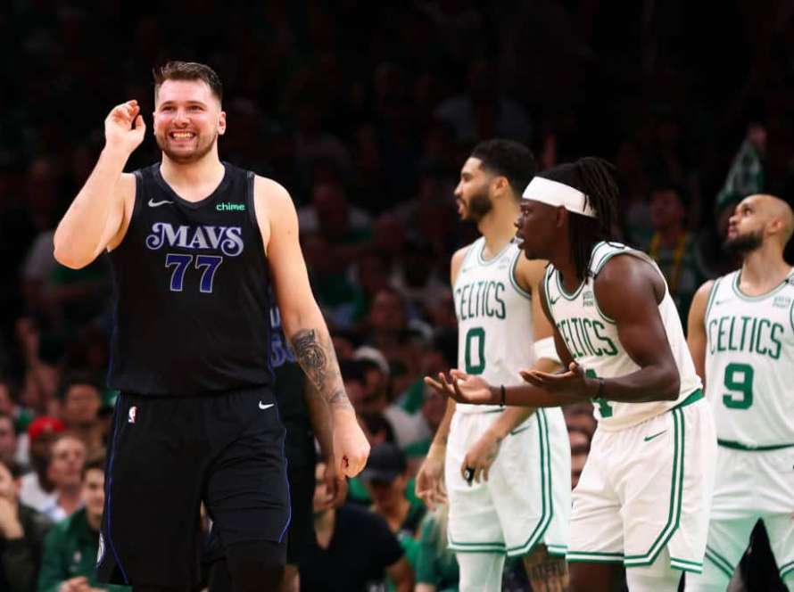 Luka Doncic #77 of the Dallas Mavericks and Jrue Holiday #4 of the Boston Celtics react during the second quarter against the Boston Celtics in Game One of the 2024 NBA Finals at TD Garden on June 06, 2024 in Boston, Massachusetts.
