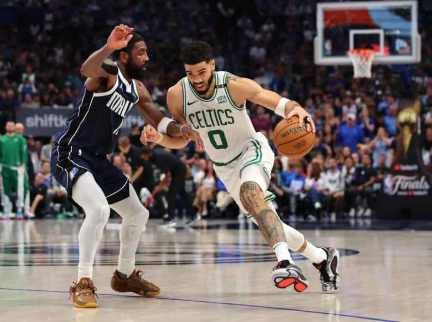 DALLAS, TEXAS - JUNE 12: Jayson Tatum #0 of the Boston Celtics dribbles the ball while being guarded by Kyrie Irving #11 of the Dallas Mavericks in the fourth quarter in Game Three of the 2024 NBA Finals at American Airlines Center on June 12, 2024 in Dallas, Texas. NOTE TO USER: User expressly acknowledges and agrees that, by downloading and or using this photograph, User is consenting to the terms and conditions of the Getty Images License Agreement.