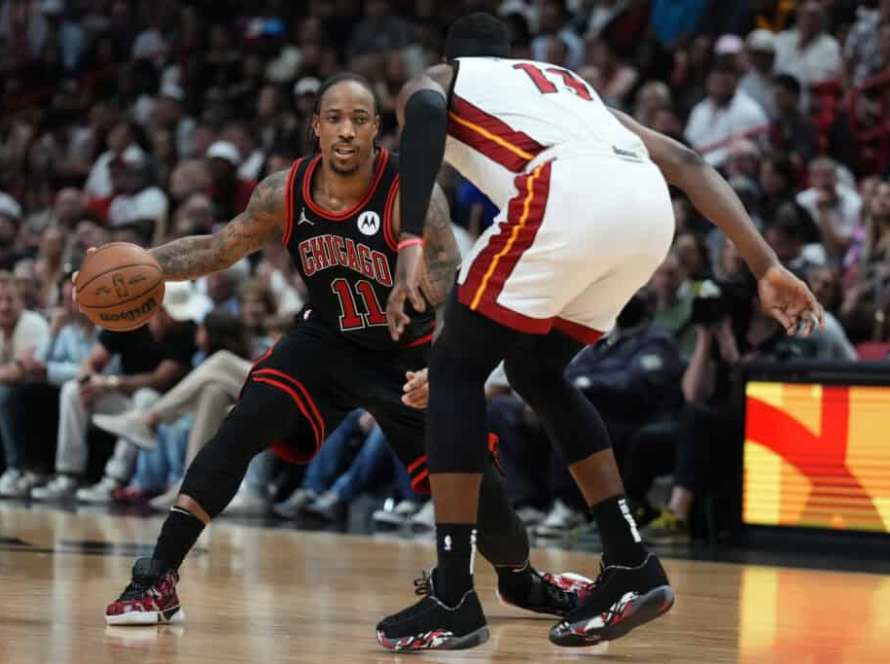 MIAMI, FLORIDA - APRIL 19: DeMar DeRozan #11 of the Chicago Bulls dribbles the ball against Bam Adebayo #13 of the Miami Heat in the fourth quarter during the Play-In Tournament at Kaseya Center on April 19, 2024 in Miami, Florida. NOTE TO USER: User expressly acknowledges and agrees that, by downloading and or using this photograph, User is consenting to the terms and conditions of the Getty Images License Agreement.